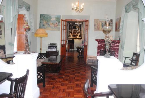 a living room with a table and a fireplace at Hostal La Chacarilla in Copacabana