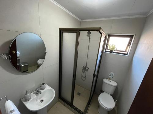 a bathroom with a shower and a toilet and a sink at Casa con vista al mar! in Tomé