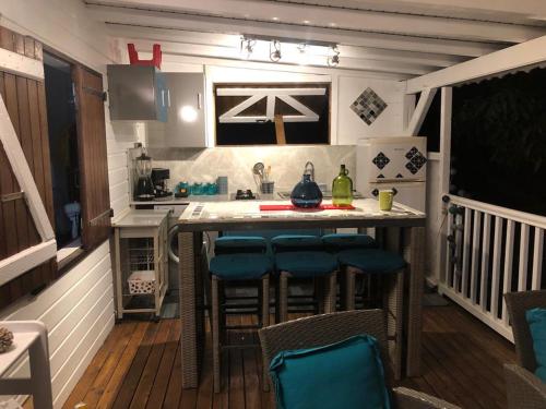 a kitchen with a island in a tiny house at Mango in Le Carbet