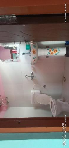 a bathroom with a toilet and a sink at Shivashram in Joshīmath