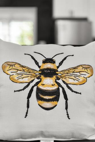 a bee on a pillow on a bed at Safari Vines Retreat in Escondido