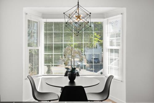 a dining room with a table and chairs and a window at Safari Vines Retreat in Escondido