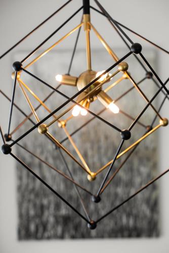 a metal and brass chandelier hanging from a ceiling at Safari Vines Retreat in Escondido