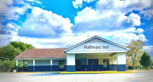 a hallimeter inn building with clouds in the sky at Hallmarc Inn in New Albany