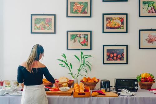 a woman standing in front of a table with food at Angkor Aurora in Siem Reap