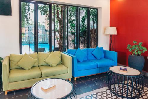 a living room with a couch and two tables at Angkor Aurora in Siem Reap
