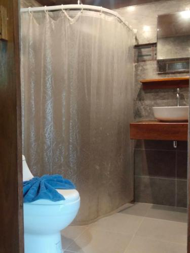 a bathroom with a shower and a toilet and a sink at Sabai House Bungalow in Ko Yao Noi