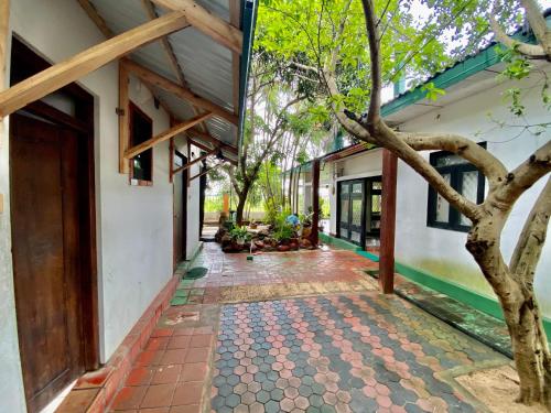 an internal courtyard of a house with a tree at Green Villa in Oluvil