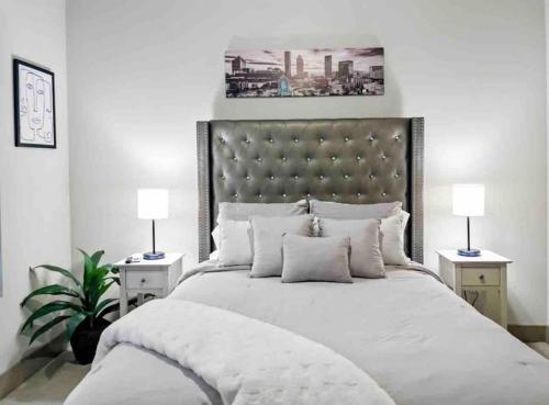 a bedroom with a large white bed with two lamps at Modern Midtown Oasis in Atlanta