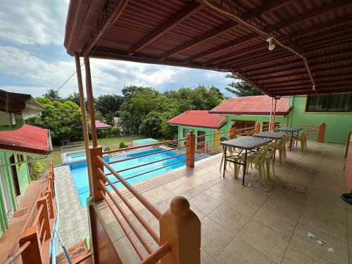 a patio with a table and chairs and a pool at DODS Apartelle in Looc