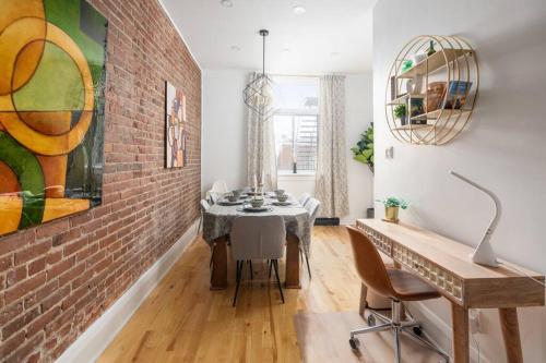 a dining room with a brick wall and a table at Downtown Luxe: Metro, King Bed, Parking, Sleeps 6 in Montréal