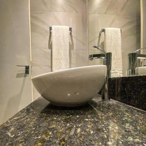 a white sink sitting on a counter in a bathroom at Rio Holiday Boutique Hotel in Niterói