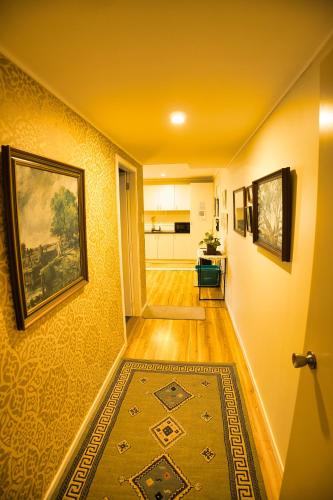 a hallway with a painting on the wall and a rug at Entire ground floor with full-privacy and family-friendly popular to ferry catchers in Wellington