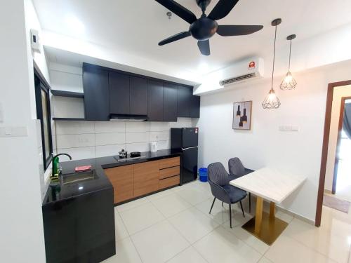 a kitchen with a table and a ceiling fan at Lovely Studio 3 pax @Sky Condo Juru Sentral in Bukit Mertajam
