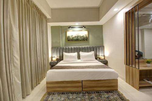 a bedroom with a large bed in a room at Saltstayz Premier - Golf Course Extension Road in Gurgaon
