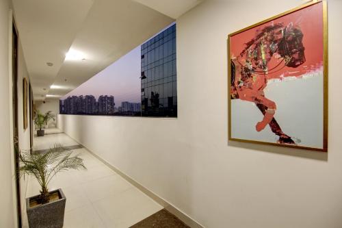 a hallway with a painting of a horse on the wall at Saltstayz Premier - Golf Course Extension Road in Gurgaon