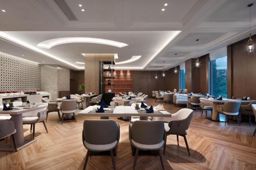 a rendering of a restaurant with tables and chairs at Crowne Plaza Dujiangyan, an IHG Hotel in Dujiangyan