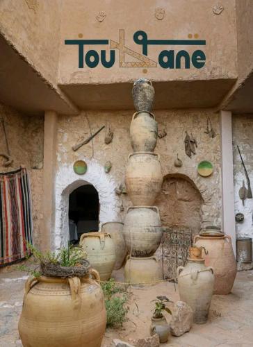 a group of large pots sitting outside of a building at Dar Fatma Toujane in Tūjān