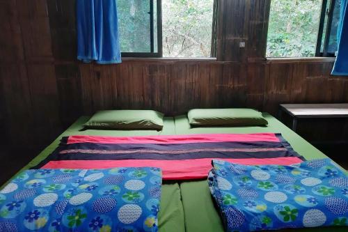 Postel nebo postele na pokoji v ubytování Doi PuMuen LAHU Homestay