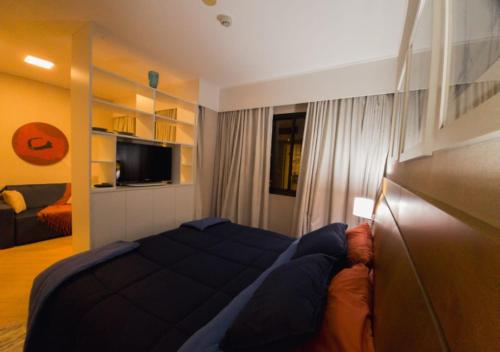 a bedroom with a bed and a television in it at The Best Deluxe - Duplex Studio - Hotel Slav Moema - by LuXXoR in Sao Paulo