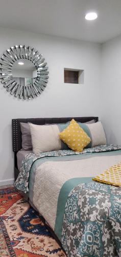 a bedroom with a bed with a mirror on the wall at Eleg Stu Apt with Lux amnts steps frm Nautical Mile in Freeport