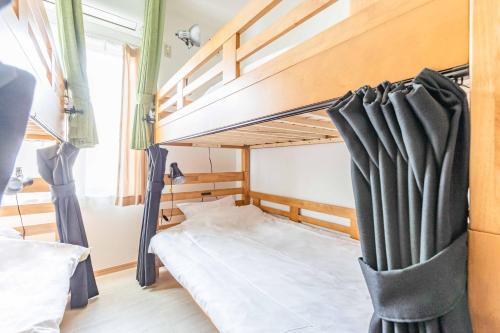 a bedroom with a bunk bed in a room at Uji Cha-gan-ju-tei House in Uji