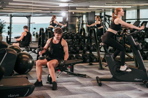 a group of people exercising in a gym at Grand Hyams Hotel - Quy Nhon Beach in Quy Nhon