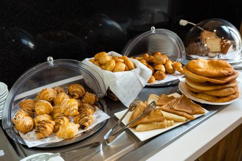 a bunch of pastries and other pastries on a counter at Hotel Dastan Aktobe in Aktobe