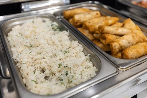 a tray of food with rice and other foods at Hotel Dastan Aktobe in Aktobe