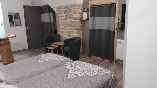 a bedroom with a bed and a table and chairs at La place Zen - Free Wifi - City Center in Nîmes