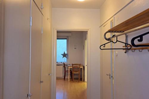 a hallway with a door leading to a dining room at Yksiö lähellä Himosta. in Jämsä
