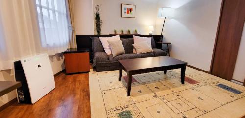 a living room with a couch and a table at Resort Yufuin - Grandpia Resort Yufuin in Yufuin