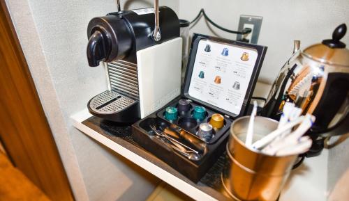 a table with a coffee machine and a tablet on it at Resort Yufuin - Grandpia Resort Yufuin in Yufuin