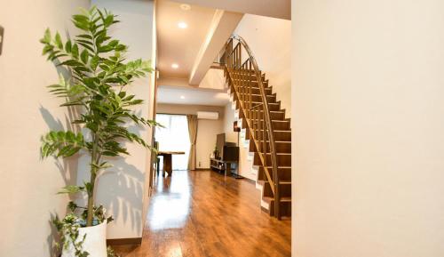 a hallway with a spiral staircase in a house with plants at Resort Yufuin - Grandpia Resort Yufuin in Yufuin
