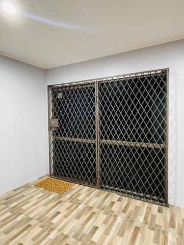 a room with a metal gate with a wooden floor at Blissful Calm in Nadi