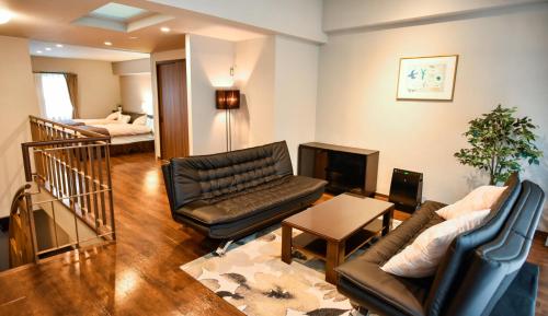 a living room with a couch and a television at Resort Yufuin - Grandpia Resort Yufuin in Yufuin