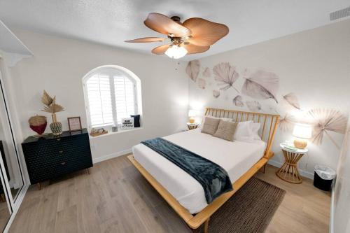 a bedroom with a bed with a ceiling fan at BOHO House - Pool, Spa, Boat Parking, Central in Lake Havasu City