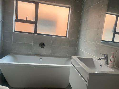 a bathroom with a white tub and a sink at 367 @ The Blyde in Pretoria