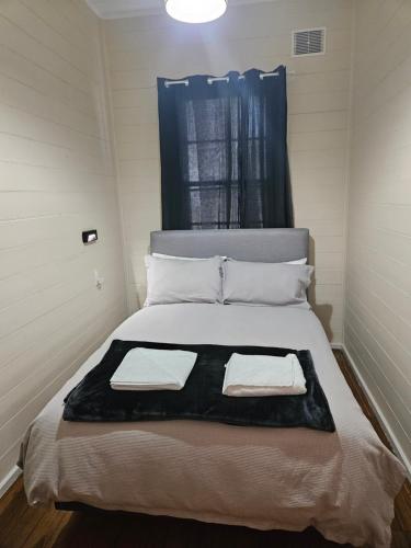 a bedroom with a bed with two towels on it at Lake Leake Inn in Lake Leake