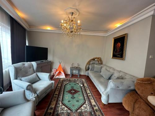 a living room with couches and a chandelier at In the city center, near metro, Şişli, Nişantaşı in Istanbul