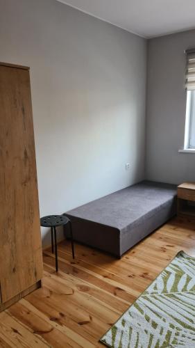a bedroom with a bed in the corner of a room at Polna 40 in Zduny