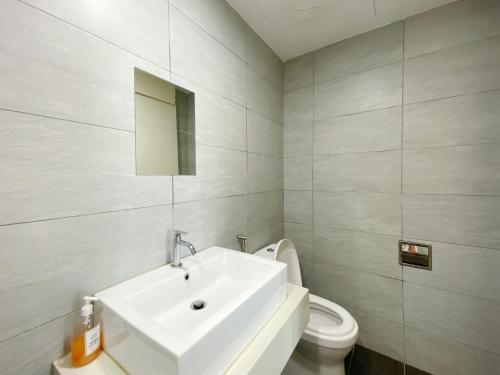 a bathroom with a white sink and a toilet at Arte Plus Ampang in Kuala Lumpur