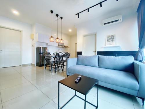 a living room with a blue couch and a table at Arte Plus Ampang in Kuala Lumpur