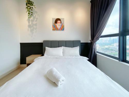 a bedroom with a white bed with a window at Arte Plus Ampang in Kuala Lumpur