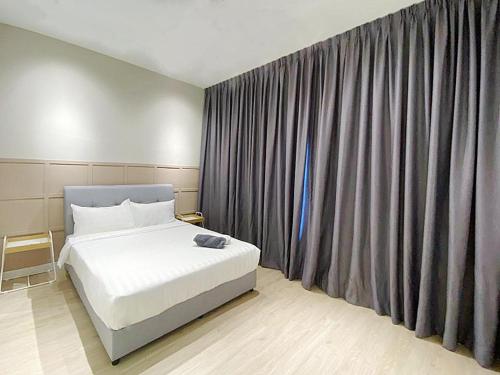 a bedroom with a bed and a large window at Arte Plus Ampang in Kuala Lumpur