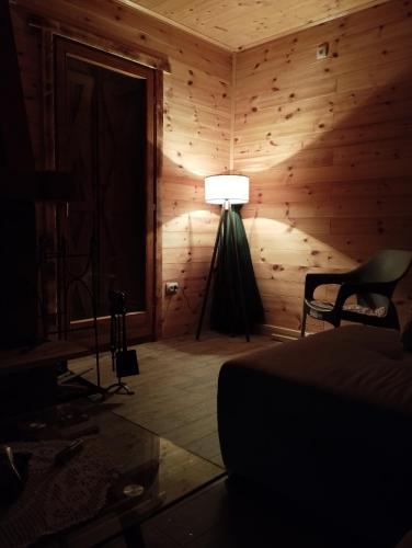 a bedroom with a lamp in the corner of a room at Brvnare Kušići in Ivanjica