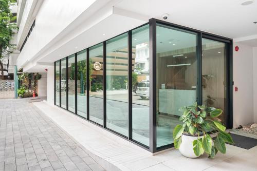 a large group of glass doors on a building at LiveZen Bangkok Sukhumvit in Khlong Toei