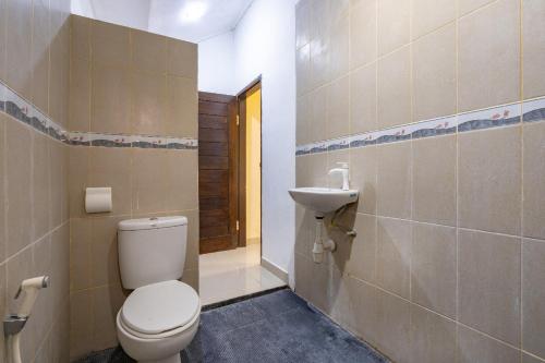 a bathroom with a toilet and a sink at Green Cottage Lembongan by ABM in Nusa Lembongan