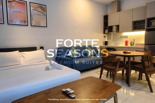 a living room with a bed and a table at Forte Seasons Genting Geo38 in Genting Highlands