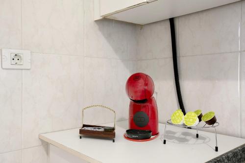 a red appliance sitting on a shelf in a room at Casa del Mar en Tacoronte in Tacoronte